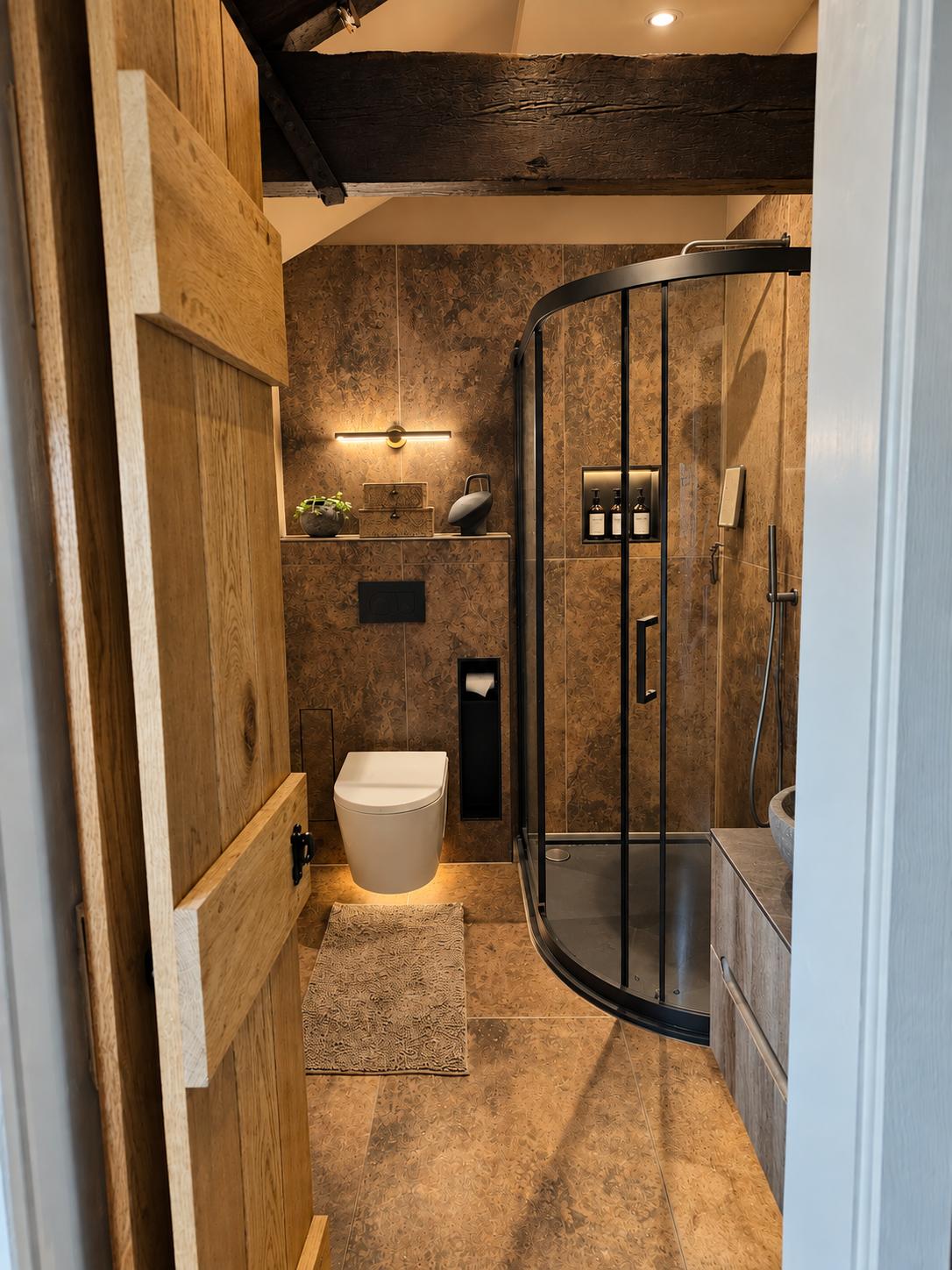 Copper-toned ensuite with curved shower enclosure and original exposed beam